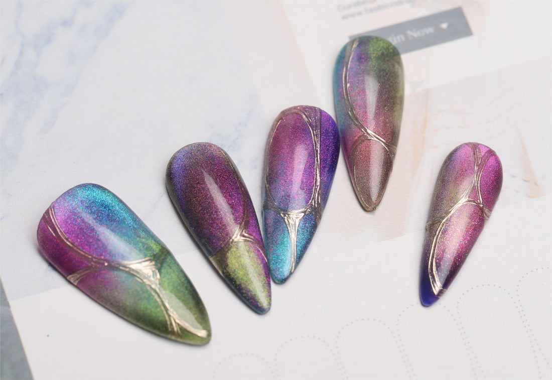 Five colorful starry cat eye nail tips with teal, purple, pink and green magnetic reflections