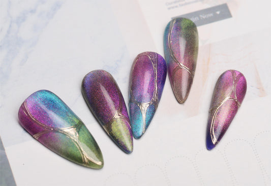 Five colorful starry cat eye nail tips with teal, purple, pink and green magnetic reflections